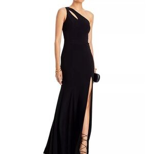 Black one shoulder gown with slit.